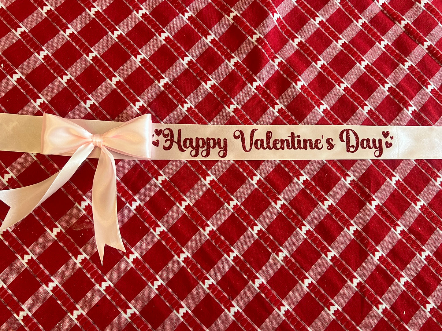 Pink ribbon with red glitter writing