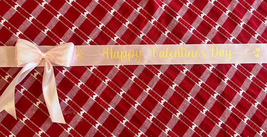 Pink ribbon with gold writing